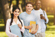 © Prostock-studio - University friends. Portrait of multiethnic teens posing outdoors with notepads and books, having break and walking in college campus