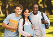 © Prostock-studio - Happy international university students having break after classes and posing with notebooks outdoors in campus, embracing and looking at camera