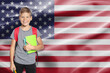 © New Africa - Little boy with backpack and stationery against flag of USA. Language school
