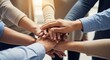 © Alice M - Diverse hands come together, symbolizing teamwork, collaboration, and unity in a professional setting.
