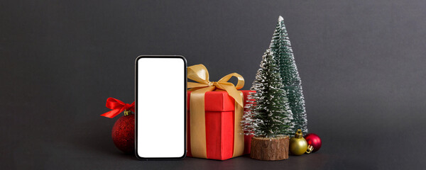 Wall Mural - Digital phone mock up with rustic Christmas decorations for app presentation with empty space for you design. Christmas online shopping concept. Tablet with copy space on colored background
