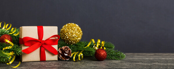 Wall Mural - New Year Christmas mood, gift box, branches of a christmas tree, New Year decorations on a colored background