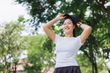 Young woman smiling, wearing cap in green park