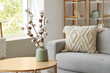 © Pixel-Shot - Vase with cotton flowers on table in modern living room