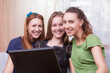 © danmorgan12 - Closeup of Group of Three Winsome Young Caucasian Funny Ladies With Laptop Searching for the Information While Having Good Time