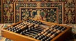 © Sumedani - Vintage Calculating Device, Traditional Abacus on Embroidered Textile Backdrop