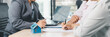 © doidam10 - Panorama view of business meeting with miniature house model on desk, real estate contract signing, property investment, mortgage loan agreement and financial planning concept. mortgage loan agreement