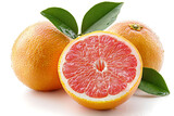 Two whole grapefruits and one cut in half with green leaves and water droplets