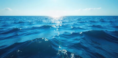Wall Mural - vast, deep blue ocean stretches to the horizon, sunlight illuminating waves and surface texture perf