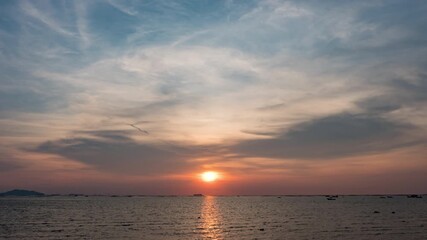 Wall Mural - Sky transform from sunset to a radiant twilight, with beautiful clouds painting the twilight horizon at a beach in the ocean.