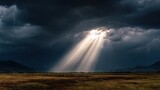 darkness. Beam of sunlight breaking through dark storm clouds, illuminating the ground. travel magazines, destination branding, designed for outdoor magazines and nature guides.