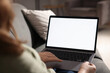 © New Africa - Woman working with laptop on sofa indoors, closeup. Mockup for design