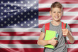 © New Africa - Little boy with backpack and stationery against flag of USA. Language school