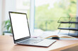 © New Africa - Laptop with empty white screen on desk in room. Comfortable home workplace