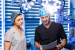 © Vadim - Surgeon consulting with nurse over medical documents. A surgeon and a nurse in medical caps discussing medical documents under bright surgical lights in the operating room.