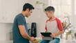 © Monkey Business - Father And Son At Home in Kitchen Following Recipe On Digital Tablet