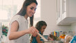 © Monkey Business - Daughter Helping Mother In Kitchen At Home Cooking Together