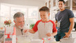 © Monkey Business - Three Generation Male Family In Kitchen At Home Having Fun Baking Together