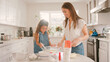 © Monkey Business - Mother And Daughter In Kitchen At Home Having Fun Baking Together