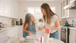 © Monkey Business - Mother And Daughter In Kitchen At Home Having Fun Baking Together