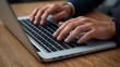 © Asawin - a person working on laptop. The picture shows the person hands with the laptop. The focus is the keyboard
