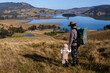 © Austockphoto - Dad with daughter walking hand in hand exploring landscape on sunlit winter morning