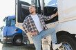 © Serhii - Young truck driver getting into semi trailer truck