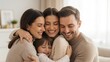 © OlgaNeuroArt - Affectionate family sharing a warm group hug in a cozy home. Happy parents and their young son embracing with love. Family togetherness and connection concept