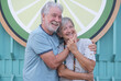 © luciano - Lovely senior couple hugging smiling standing in outdoors looking at camera happily. Youthful couple enjoying retirement lifestyle