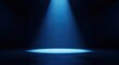 © MDRifat - Dramatic blue spotlight illuminates empty stage floor creating