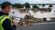 © sayuran - Drone surveying flooded disaster area with man using tablet.