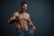 © Prazis Images - Happy Muscular Man Showing His Weight Loss Progress