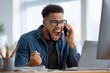 © Prazis Images - Angry African American Man Shouting at His Phone in the Office