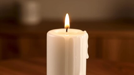 Wall Mural - Elegant timelapse of a white pillar candle burning down, wax melting and flame flickering interior, transformation, zen