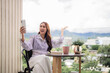 © snowing12 - Adult Asian woman enjoying video call from home balcony happy communicate lifestyle sharing moments mobile technology