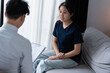 © Charlie's - sad female sitting on sofa Patient discussing mental health issues with psychologist. depressed asian woman mental health treatment