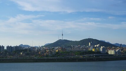Wall Mural - Wide shot of the Seoul city skyline featuring Namsan Tower and the Yongsan district with the Han River and a large blue sky for copy space