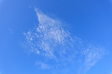 Wall Mural - The sky is blue and clear with a few clouds scattered throughout
