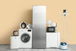 © Pixel-Shot - Different household appliances near beige wall