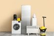 © Pixel-Shot - Different household appliances near beige wall
