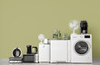 © Pixel-Shot - Different household appliances near green wall