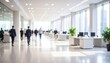 © wanna - Crowd of business people walking with motion blur in an airport or office corridor