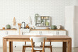 © Pixel-Shot - Interior of stylish kitchen with dining table, white counters and sink