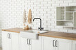 © Pixel-Shot - Interior of stylish kitchen with white counters, sink and shelf