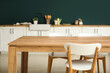 © Pixel-Shot - Empty wooden dining table with chairs in stylish kitchen