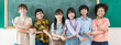© paulaphoto - Diverse group of cheerful school children stand together in front of chalkboard, link arms show teamwork friendship, back to school banner