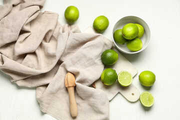 Wall Mural - Bowl and cutting board with fresh ripe limes on white background