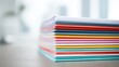 © Mrammon - A stack of colorful papers on a table
