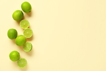Wall Mural - Fresh ripe limes on yellow background