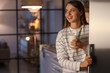 © Pixel-Shot - Young woman with glass of milk near open fridge in kitchen at night